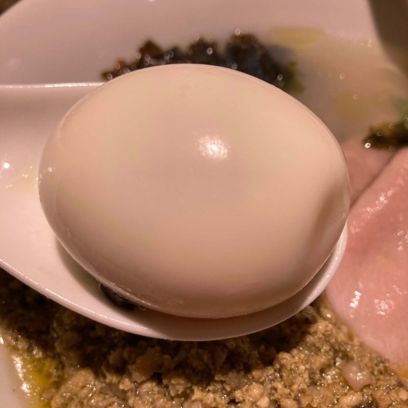 中野坂上【らぁめん 希いろ】の味玉をレンゲに乗せて
